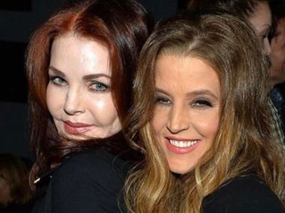 Priscilla Presley and Lisa Marie Presley are cozying to each other as they are posing for the picture. 